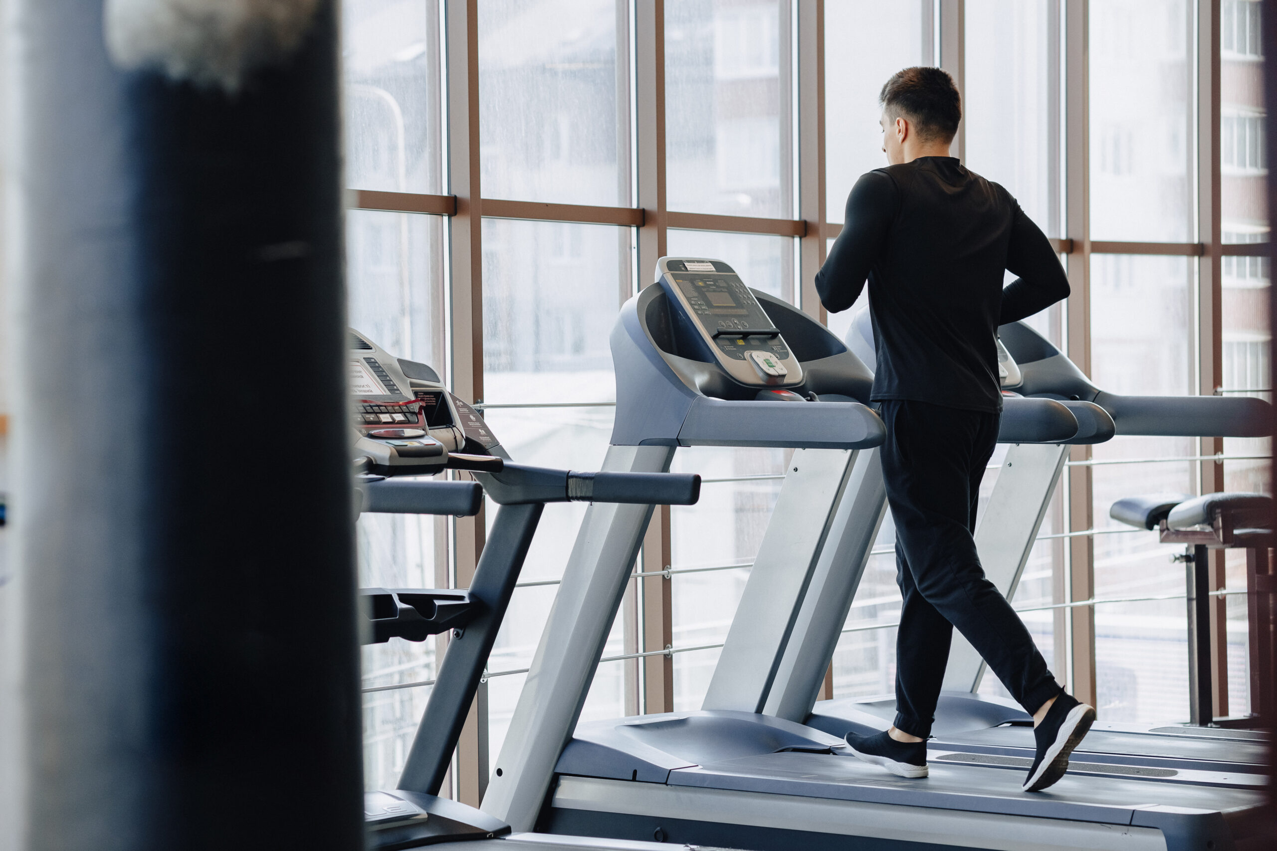 stylish guy in the gym is training on the treadmill. Healthy Lifestyle. wellness.